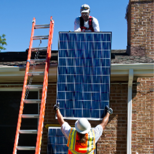 Workers installing solar panels on a residence
